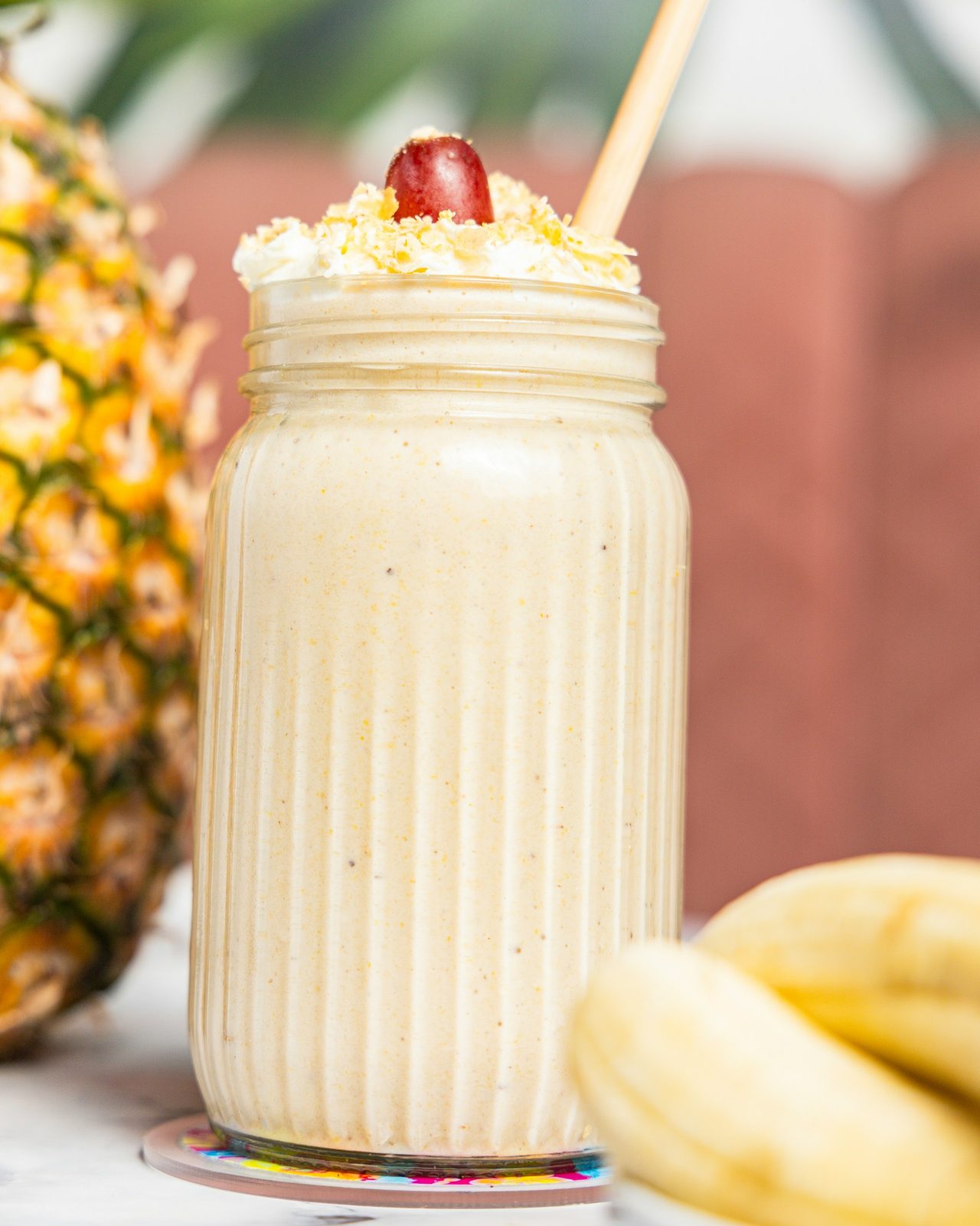 Smoothie in a glass jar with pineapple and banana