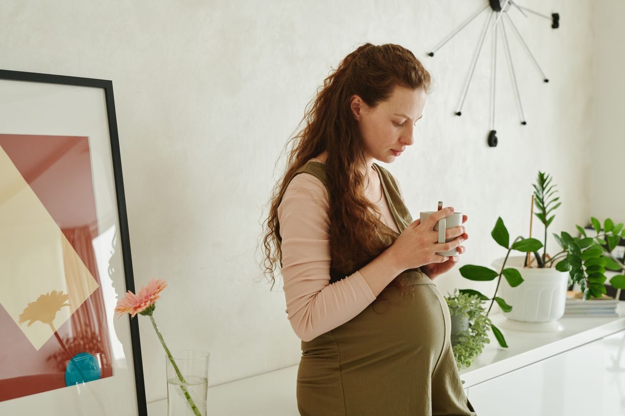 Pregnant woman in a quiet, reflective moment