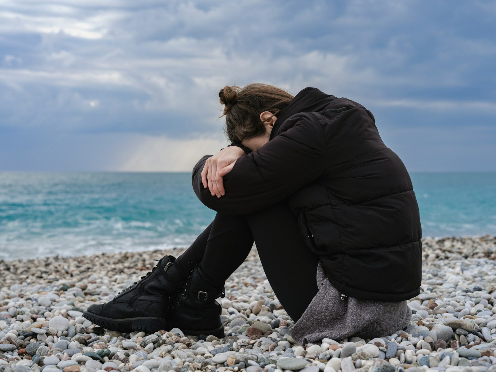 Person sitting quietly in a calm, soft-lit setting, reflecting feelings of anxiety