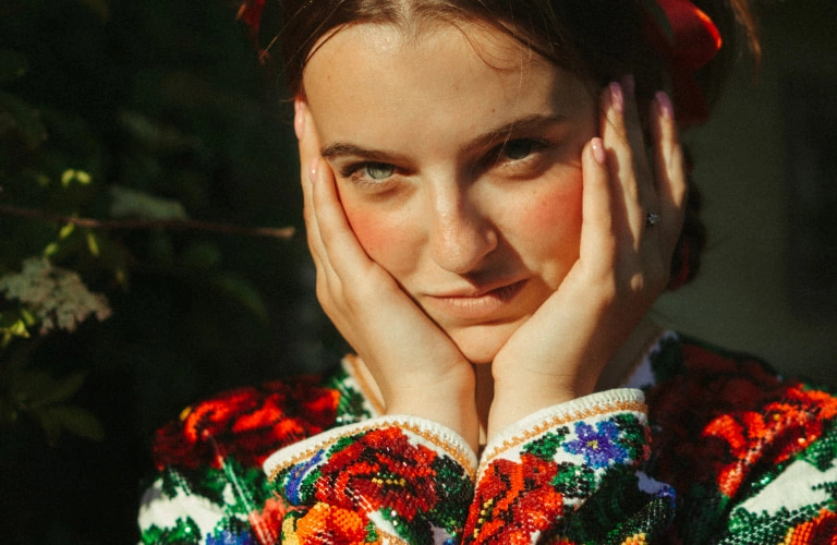 woman holding hands on face, admiring her skin after naturopathic acne treatment