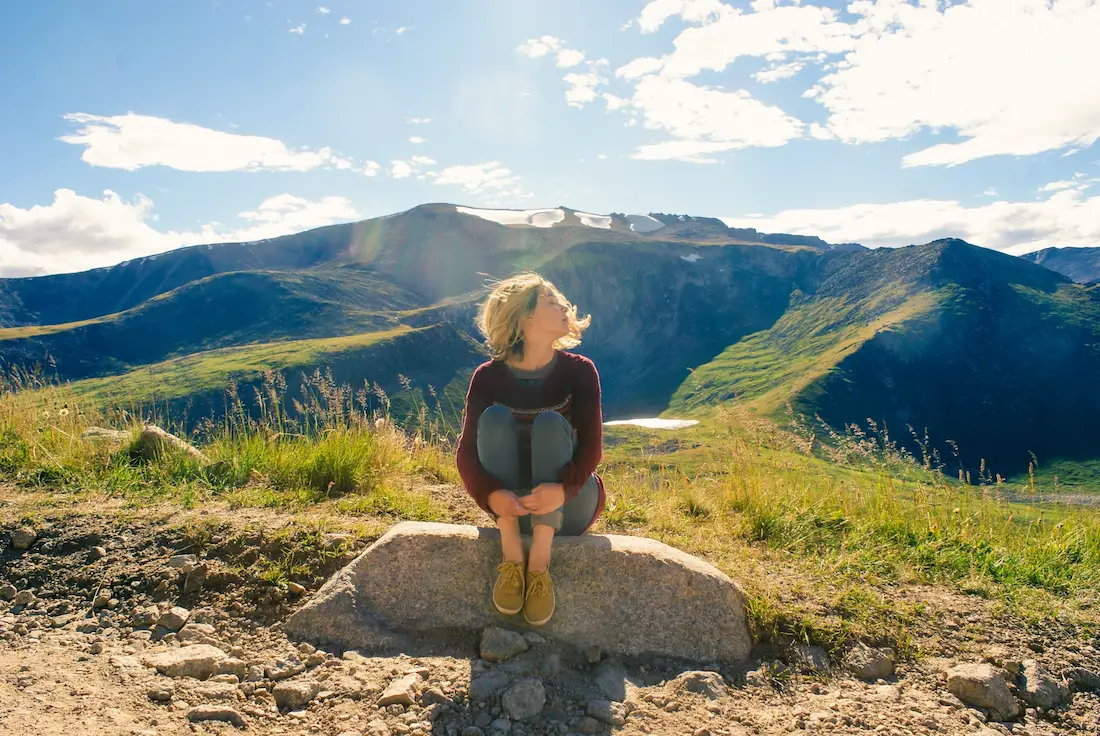 woman with pcos sitting on a rock