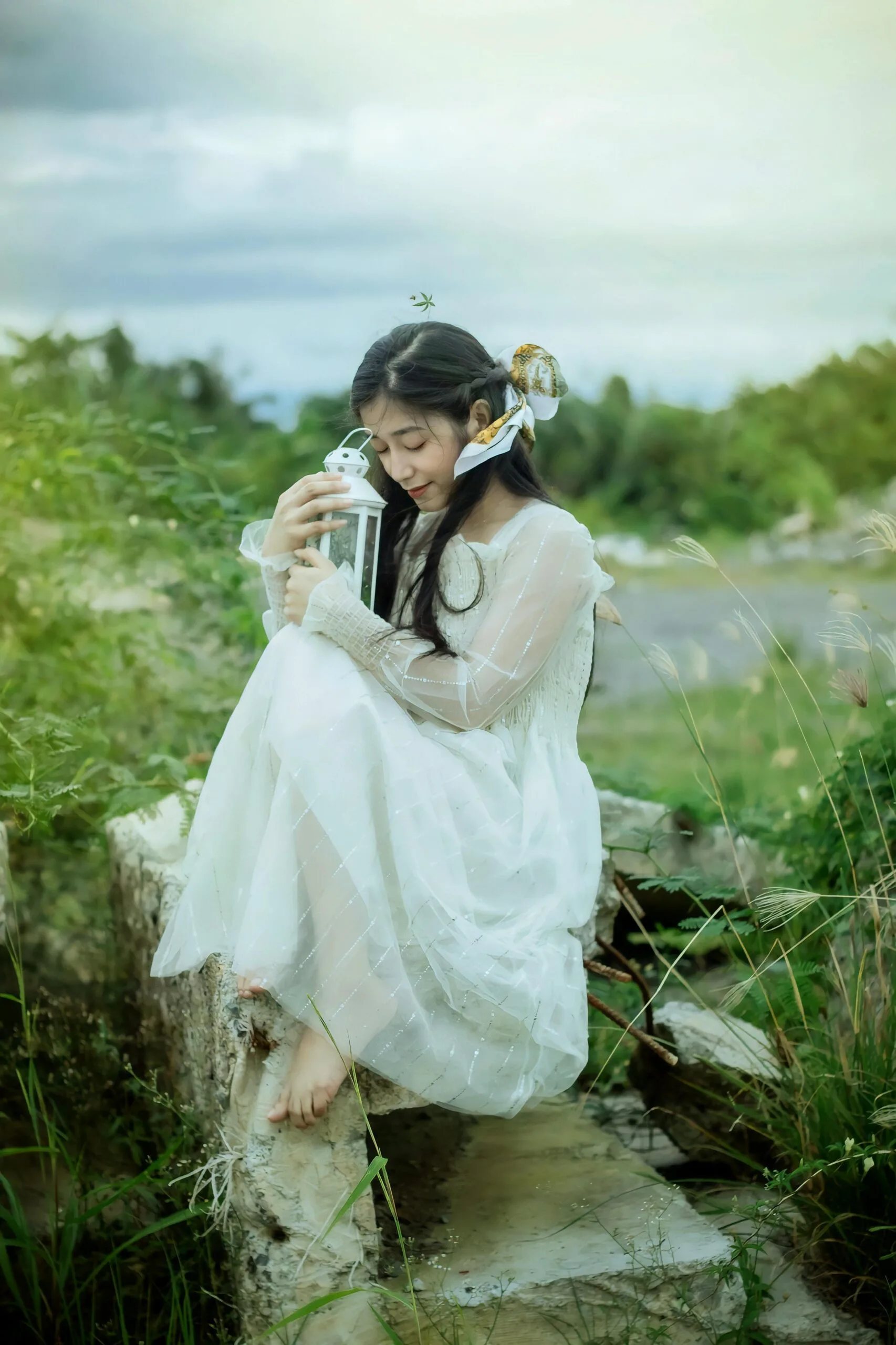 Peaceful woman in nature holding a lantern, symbolising gentle naturopathic support for PCOS and hormonal balance