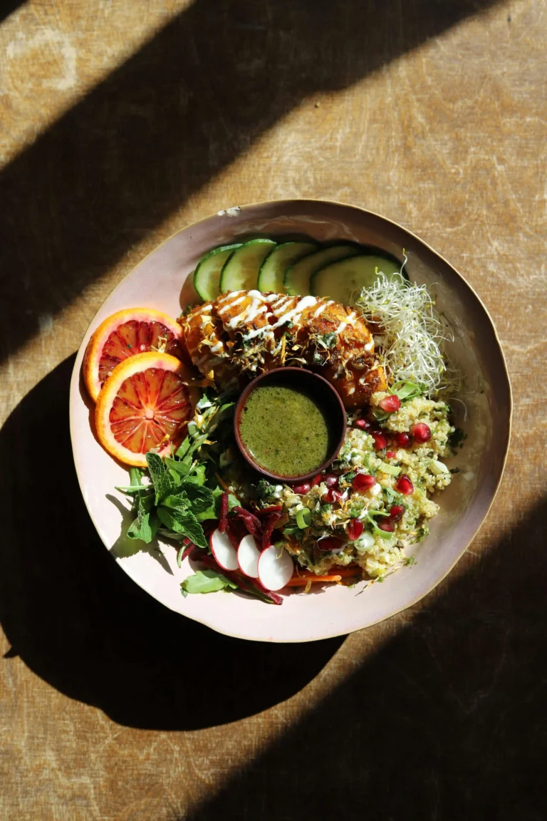 A colorful spread of gut‑friendly foods including fermented vegetables, leafy greens, nuts, and seeds, styled in a warm wellness setting.