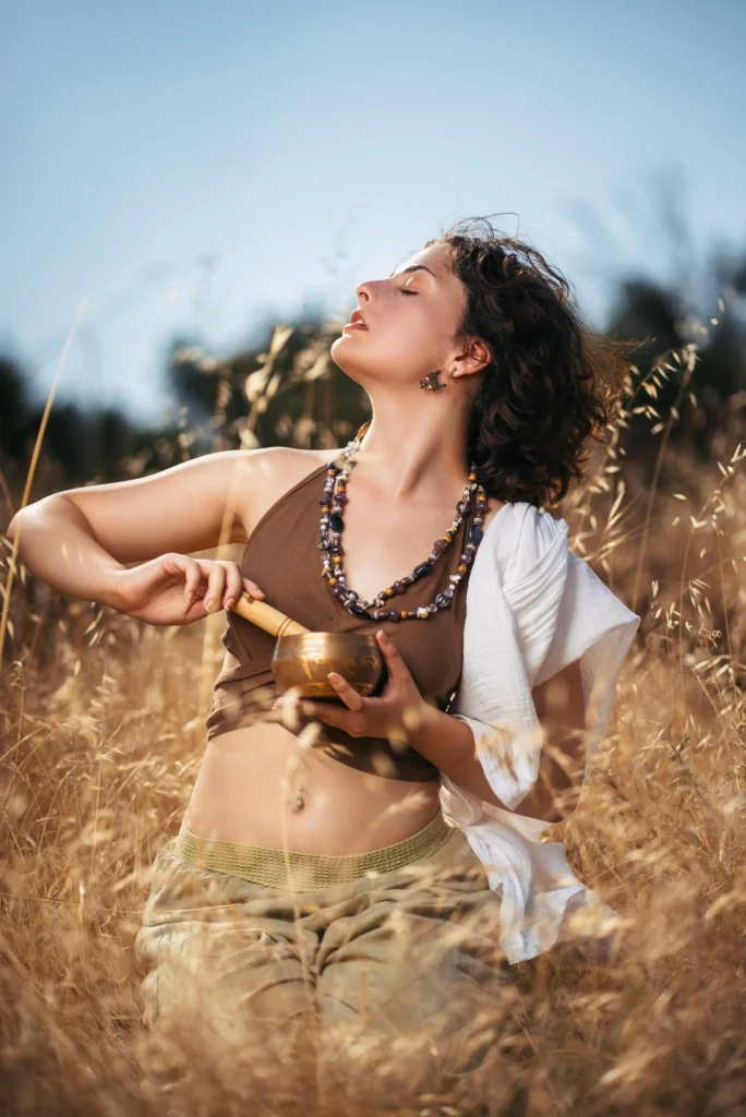 Woman practicing seated yoga and meditation by a window, symbolizing stress relief and mindful movement for gut wellbeing